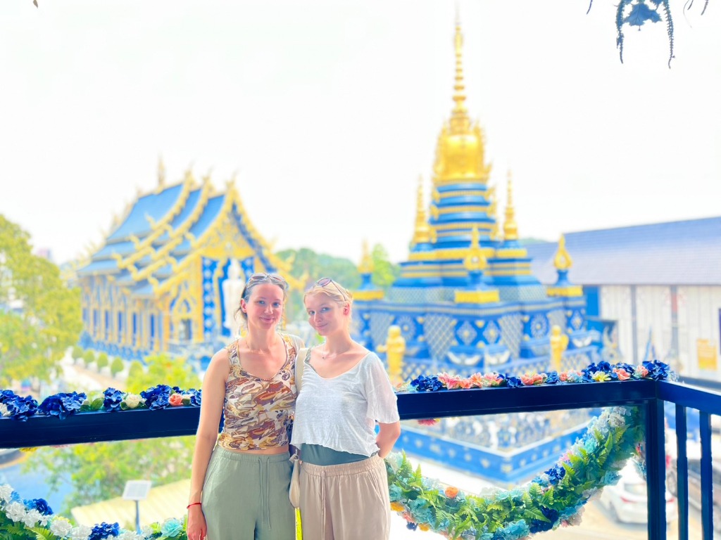 Smiling travelers at Blue Temple Chiang Rai